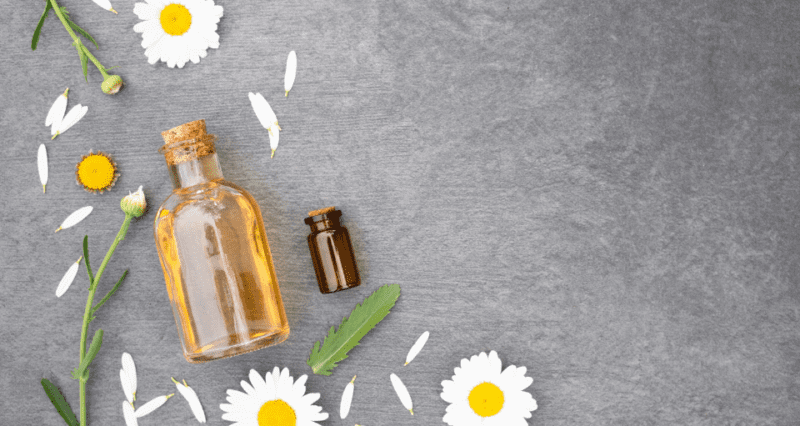 essential oil bottles and chamomile flowers on a gray background, Mission Farms CBD
