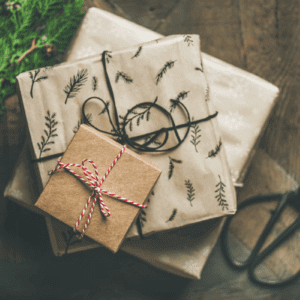 presents wrapped in brown paper with red and whtie colored string